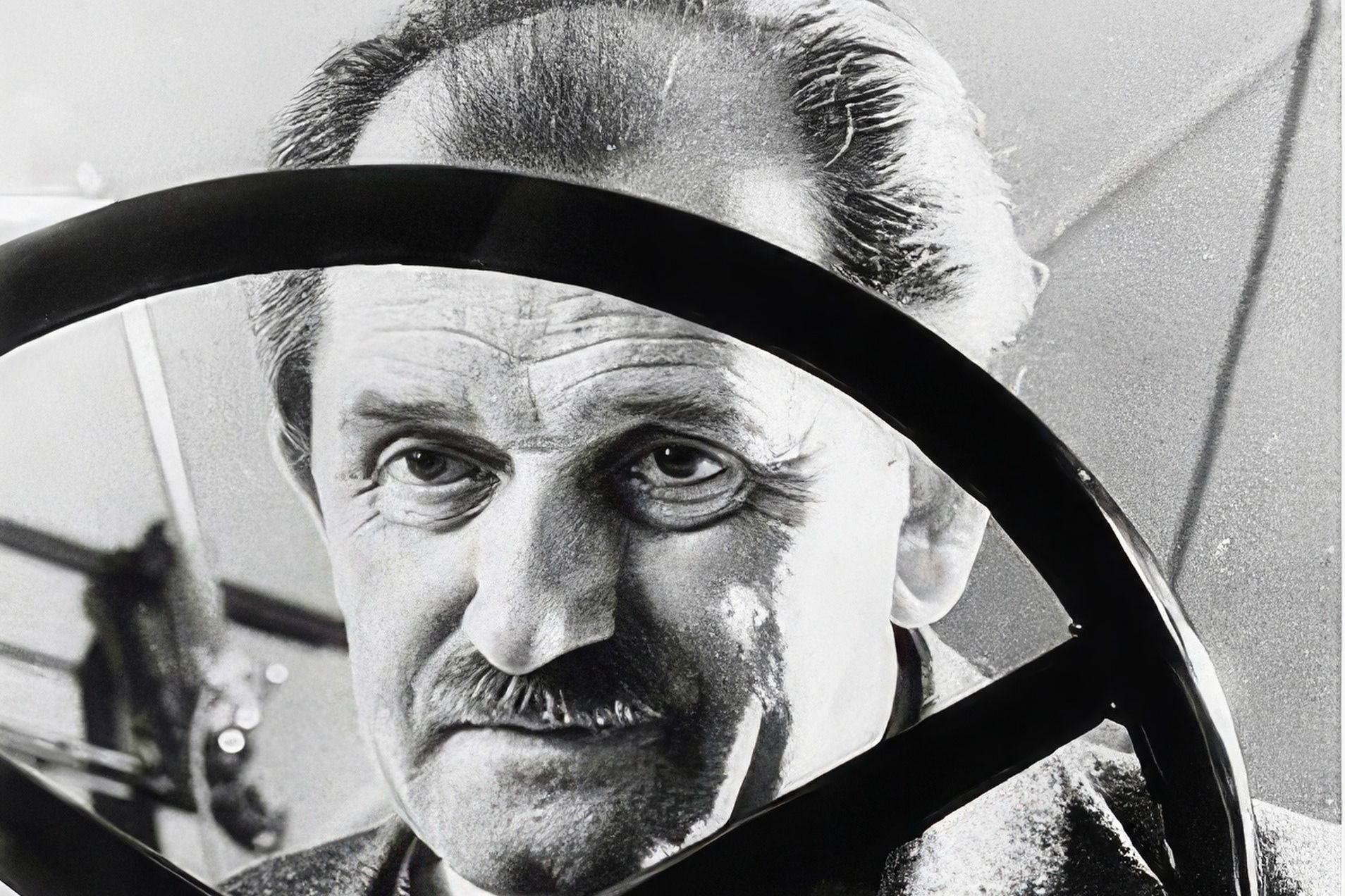 Ferdinand Porsche behind a steering wheel
