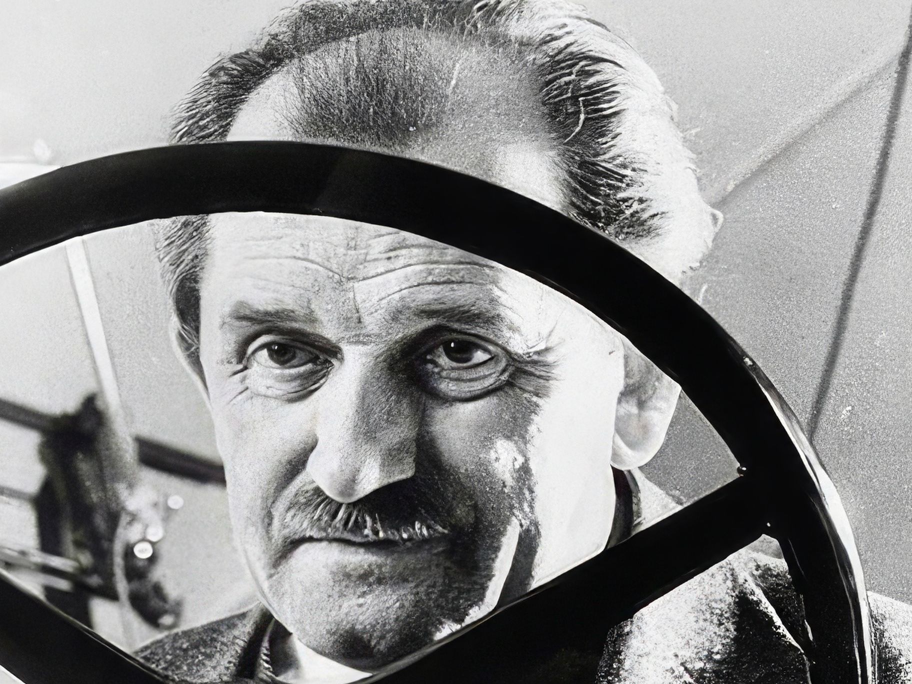 Ferdinand Porsche behind a steering wheel