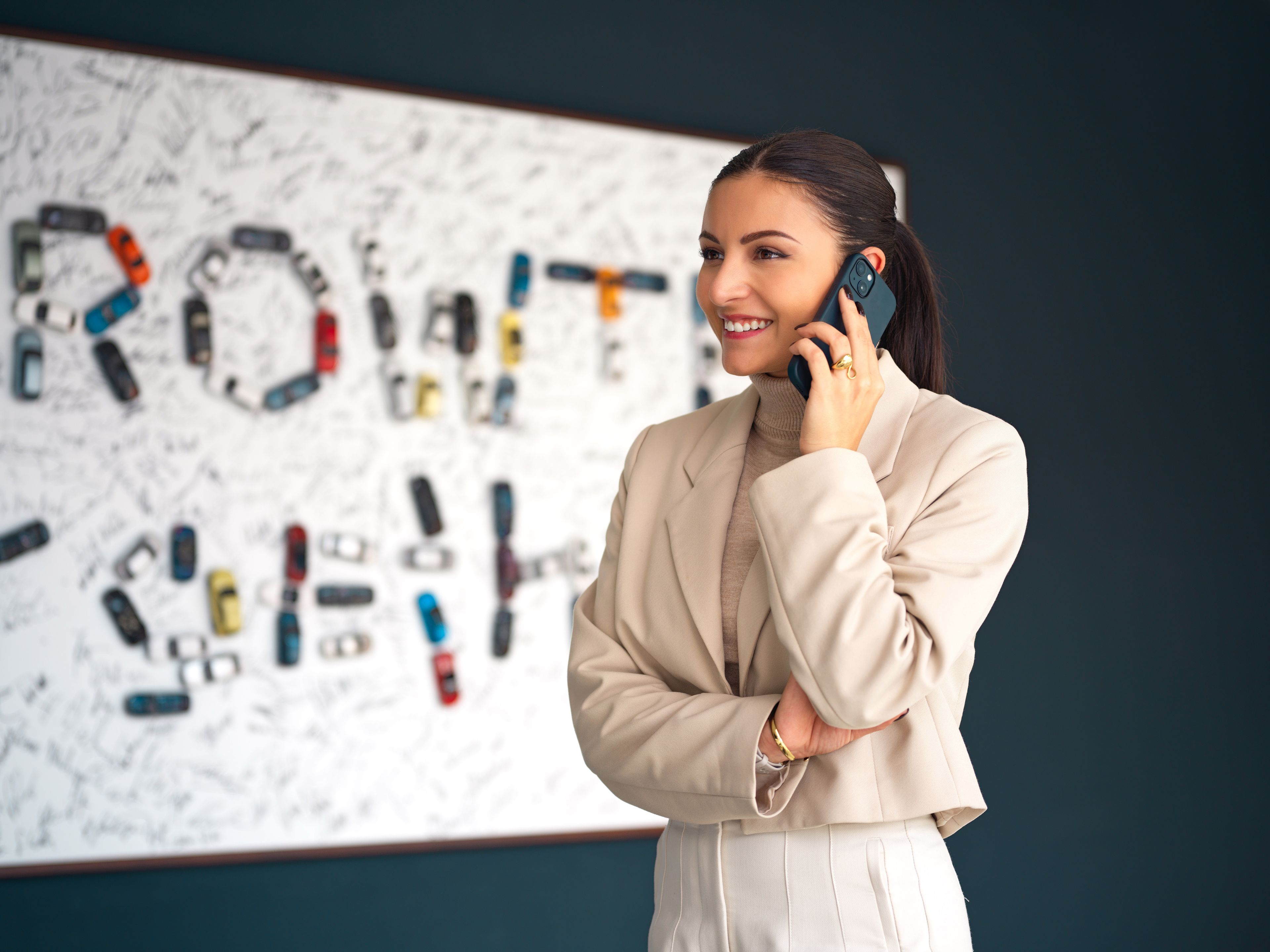 Young woman on the phone in an office environment.