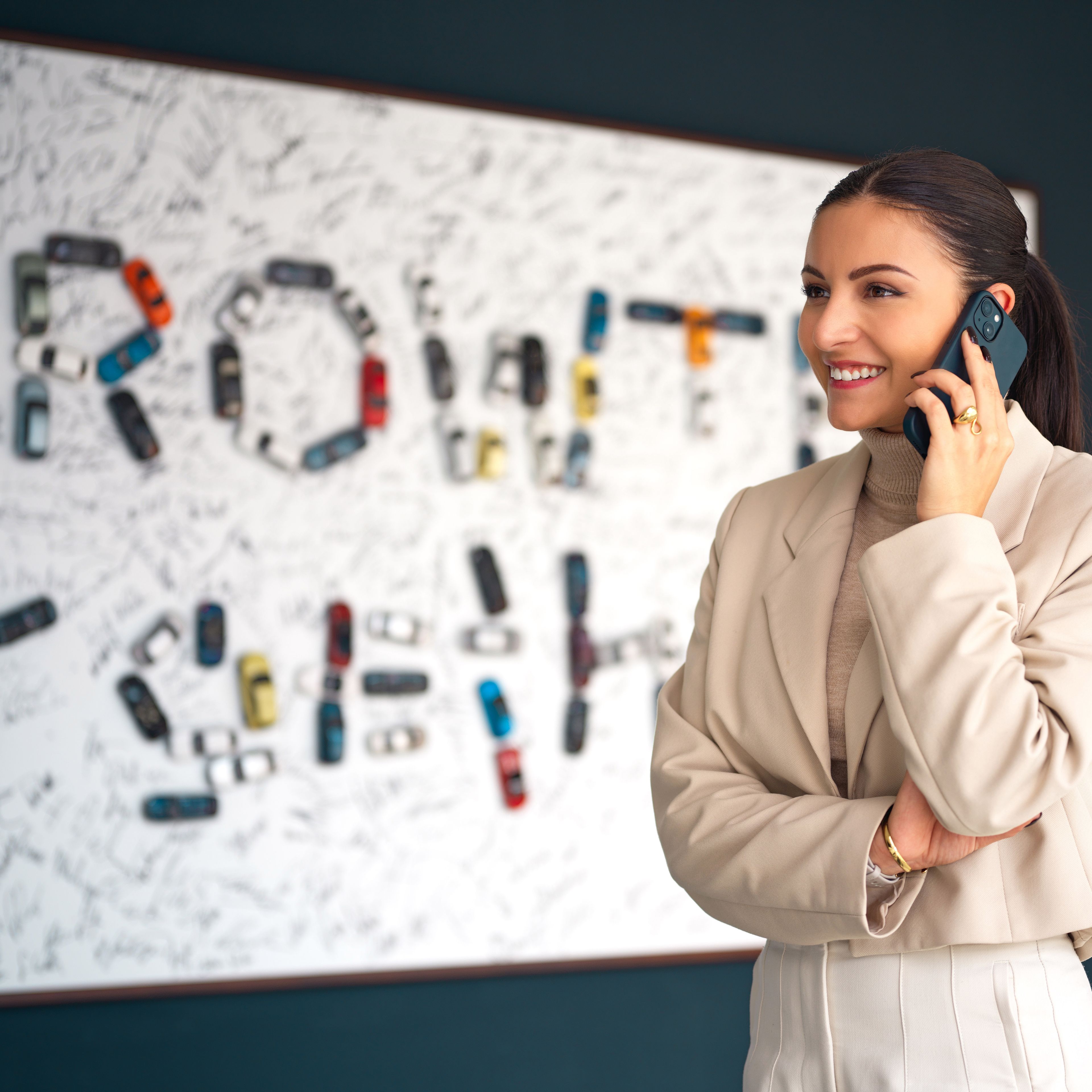 Young woman on the phone in an office environment.