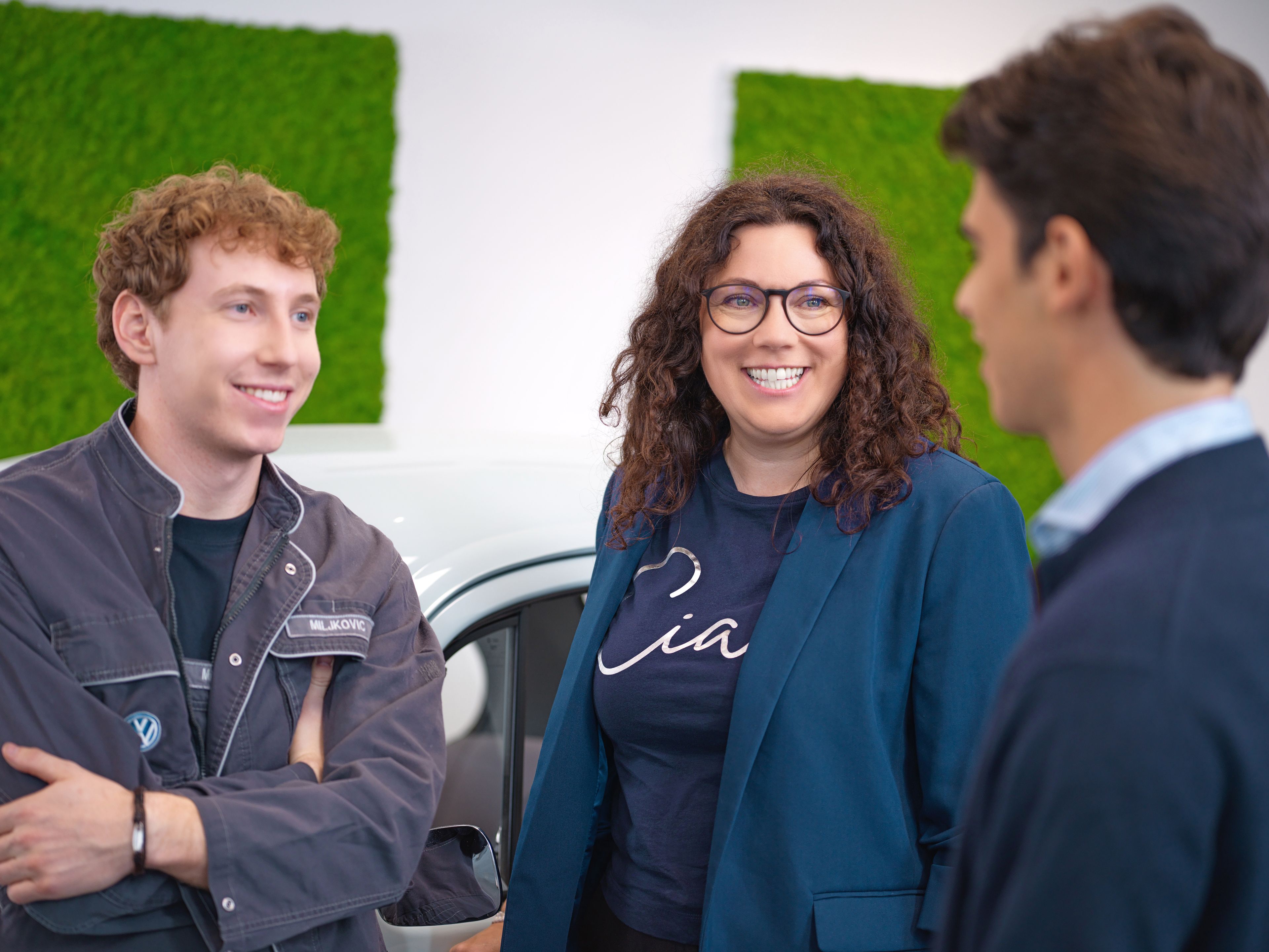 Three people are talking.