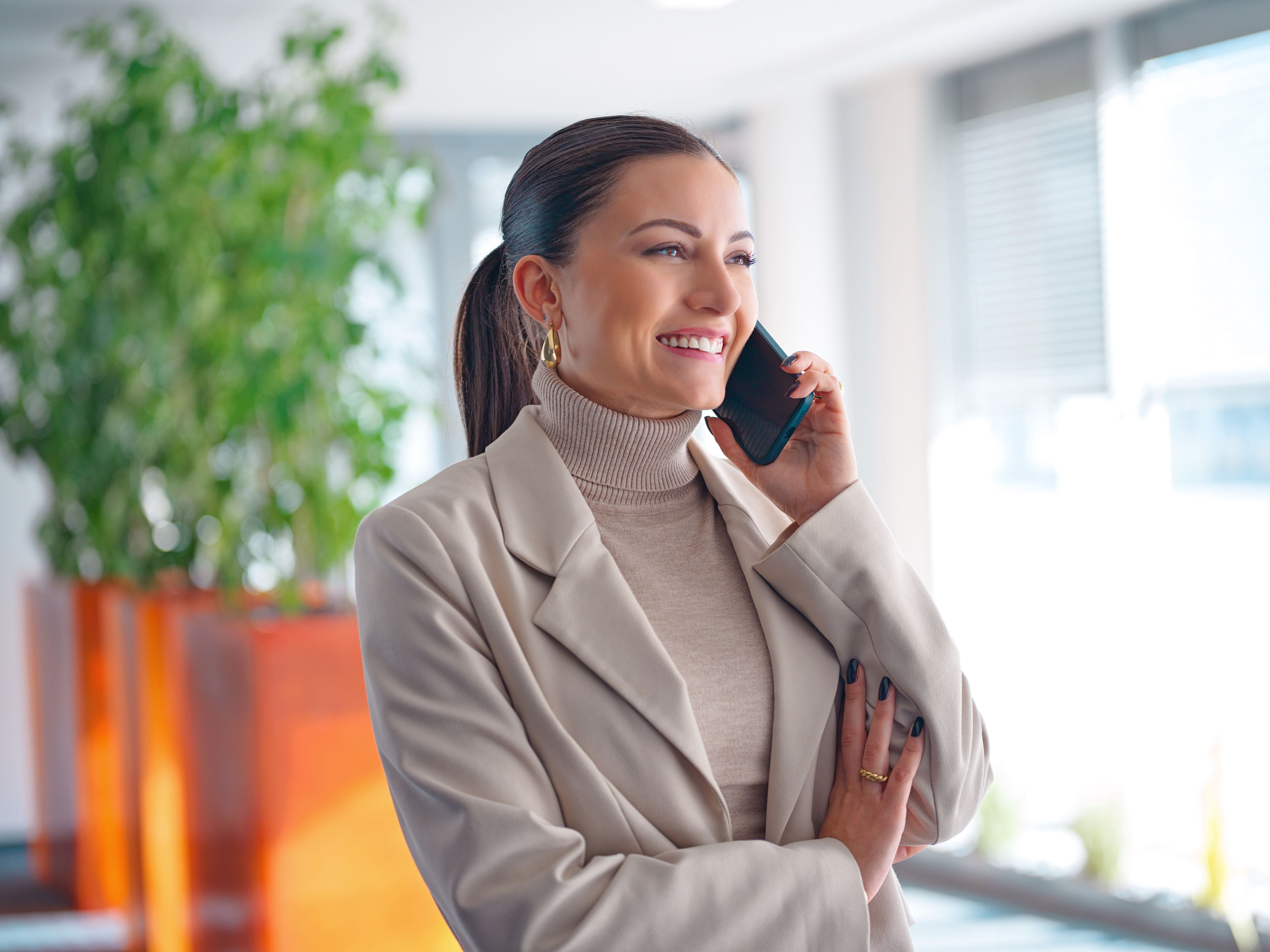 Young woman on the phone in an office environment.