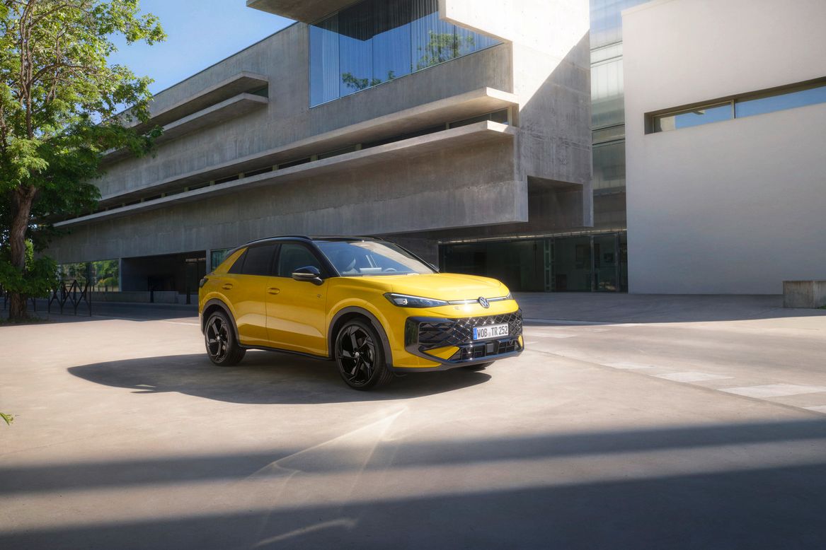 Yellow VW R-Roc outside of a modern building