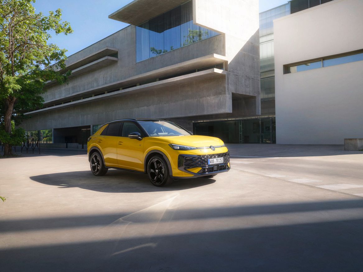 Yellow VW R-Roc outside of a modern building