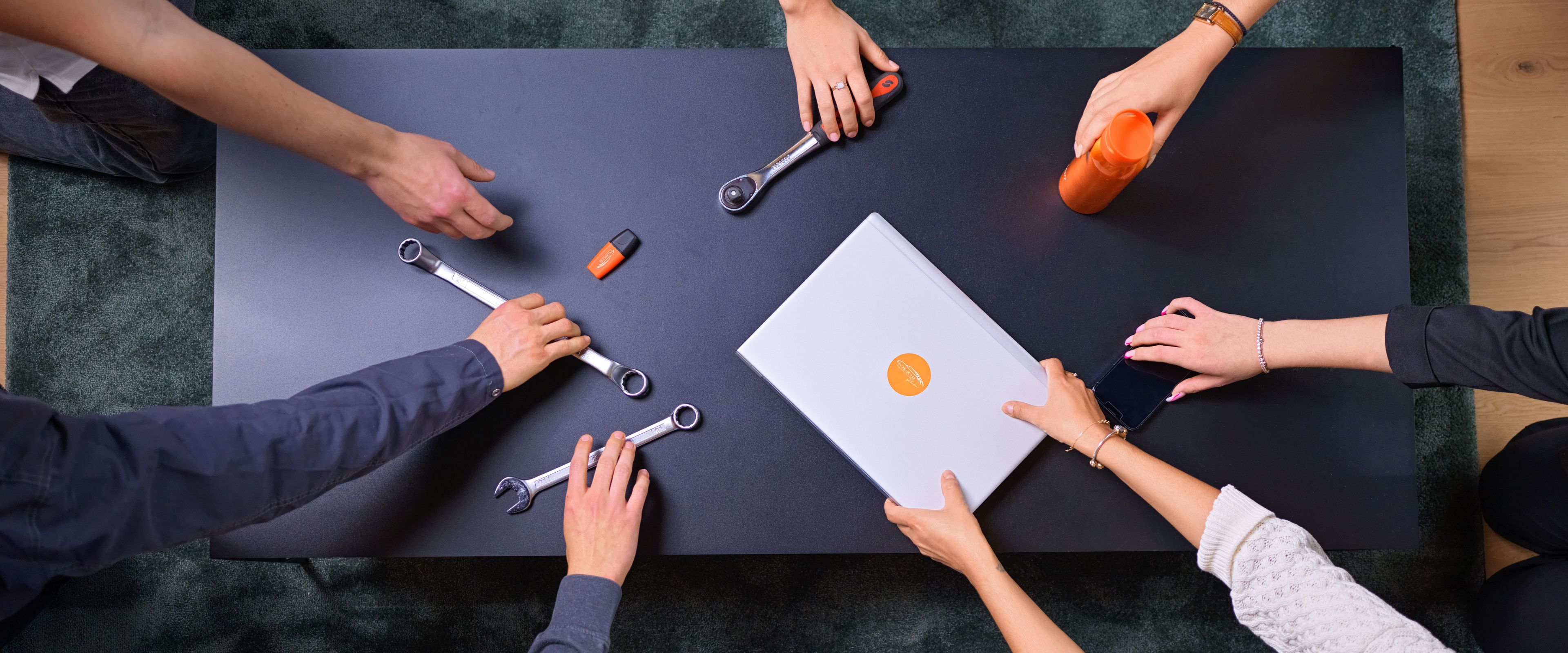 hands on a table grabbing different tools