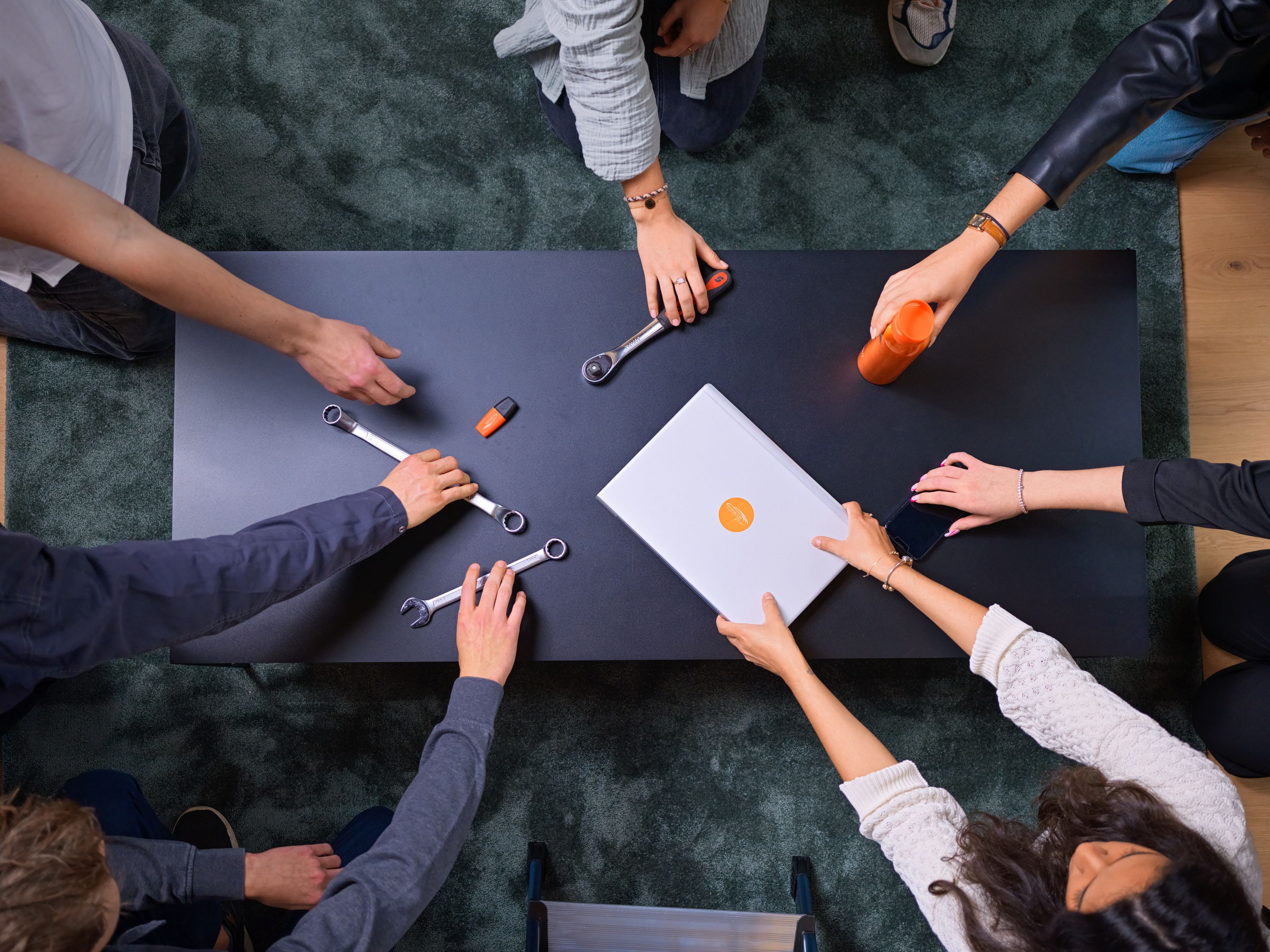 hands on a table grabbing different tools
