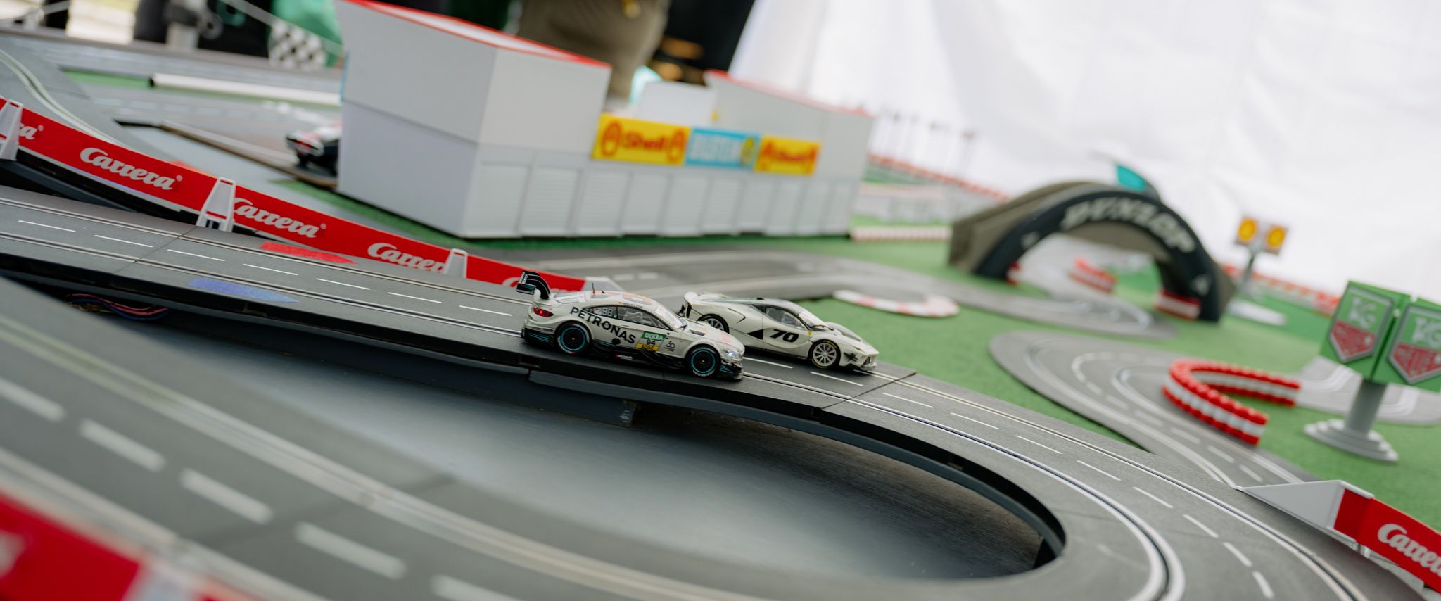 Two cars compete on a model track.