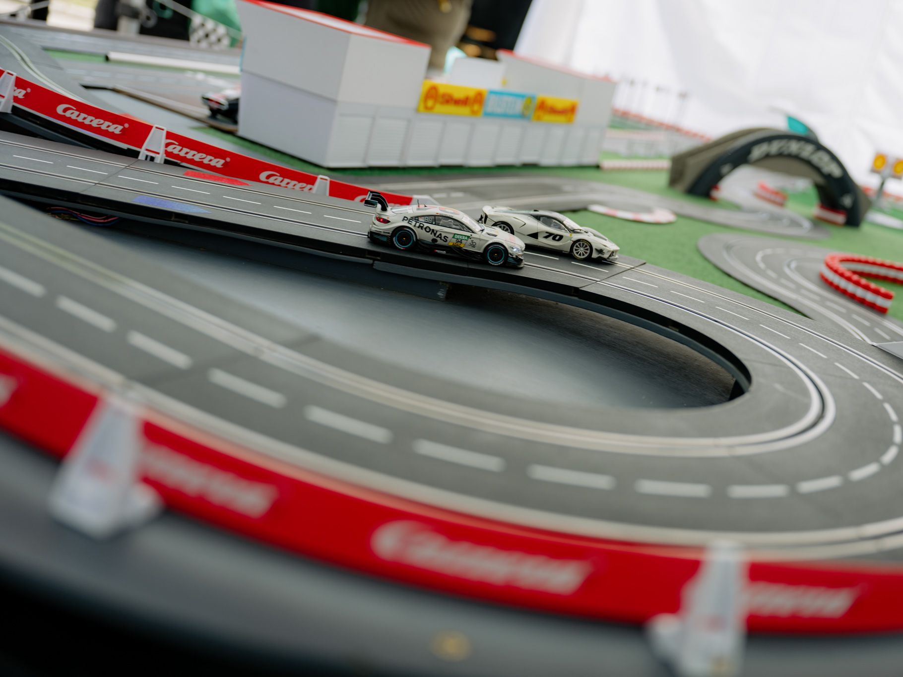 Two cars compete on a model track.