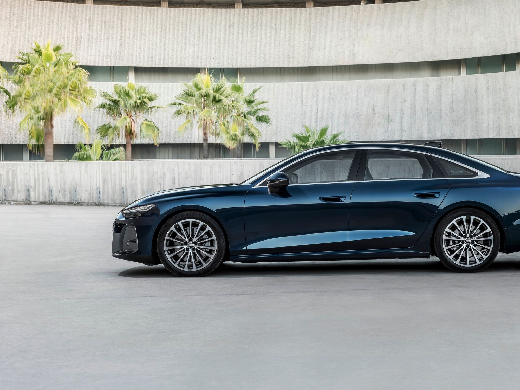 Blue Audi A8 in a clear yard