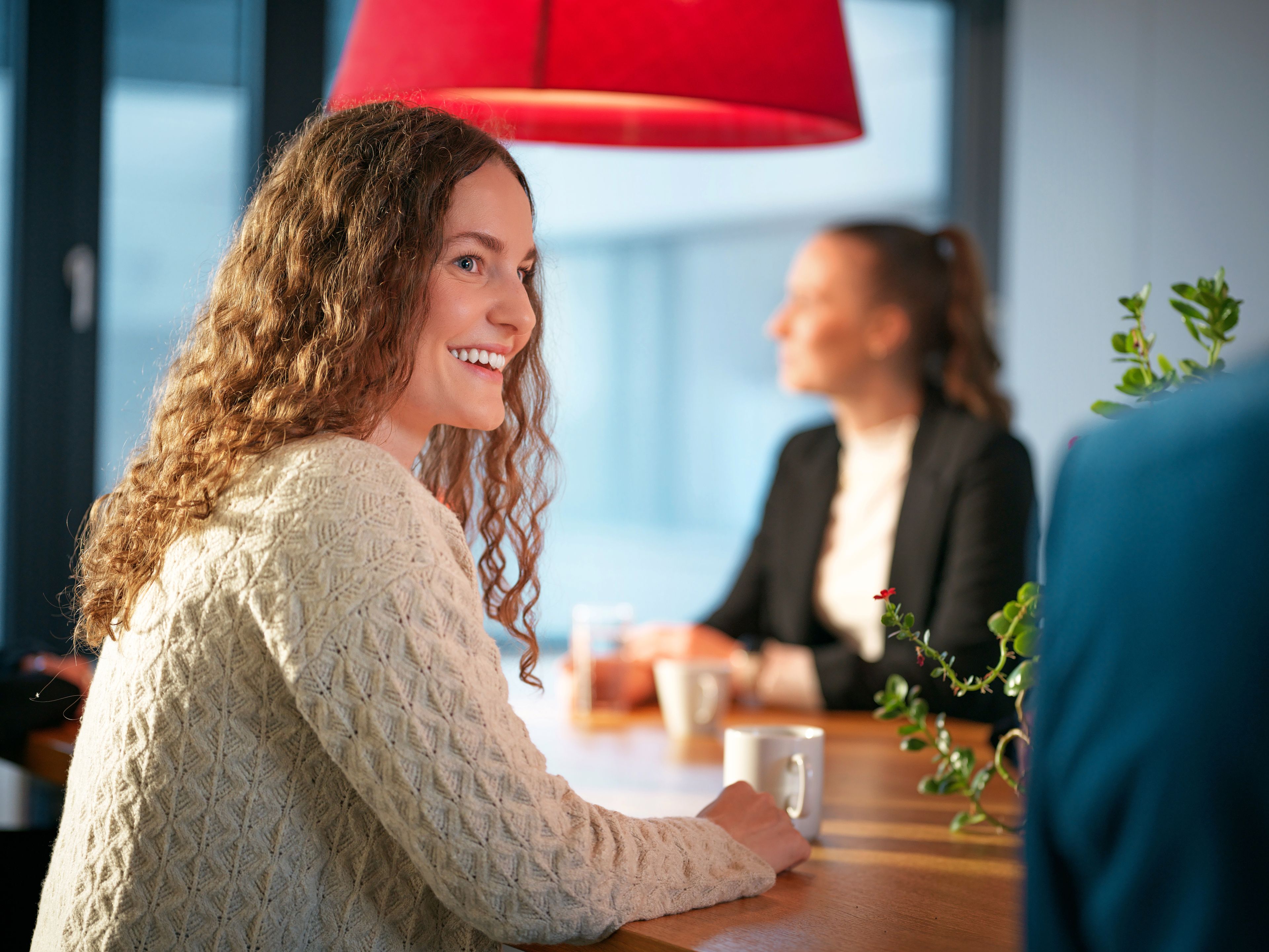 A young lady is sitting in a café.